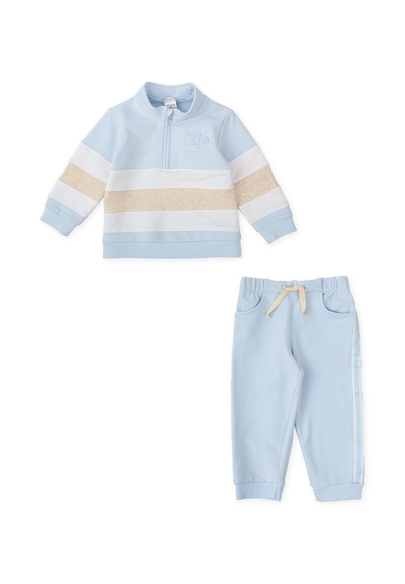 Sudadera azul claro con cremallera, rayas blancas y beige, logo bordado. Pantalones de chándal azul claro a juego con cuerda ajustable y rayas laterales.
