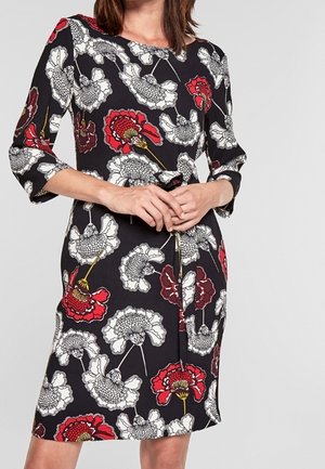 Robe florale avec une base noire, ornée de coquelicots blancs et rouges. Manches trois-quarts et coupe au genou. Tissu lisse avec un léger éclat.