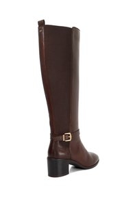 Brown leather knee-high boot with a textured fabric panel, square toe, and a side buckle detail. Features a sturdy block heel.