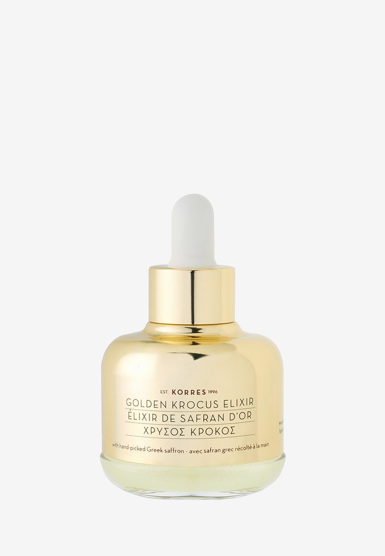 Gouden Krocus Elixir in een cilindrische gouden fles met een witte pipet. De tekst op het etiket bevat de productnaam en details over saffraan.