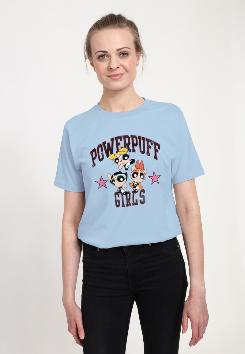 Světle modré bavlněné tričko se grafikou tří kreslených postaviček a textem "Powerpuff Girls" s růžovými hvězdnými akcenty.