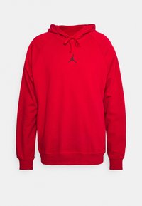 Sweat à capuche rouge à coupe décontractée, en tissu mélangé coton, avec un logo Jordan noir sur la poitrine et des poignets côtelés.