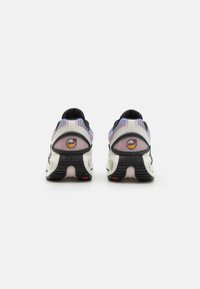 Sport shoes featuring a mesh upper with gradient color, black accents, a cushioned sole, and prominent rubber tread for traction.