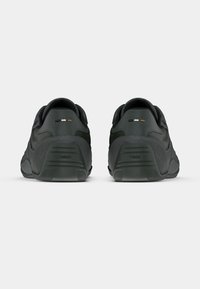 Czarne sneakersy z połączeniem gładkich i teksturowanych materiałów. Posiadają wyściełany kołnierz, logo oraz kontrastowe akcenty przy pięcie.