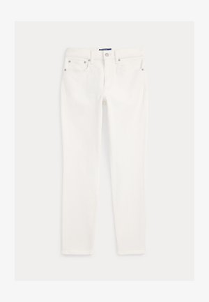 Skinny jeans brancos com fecho frontal, passadores de cinto e estilo de cinco bolsos, dispostos sobre um fundo liso.