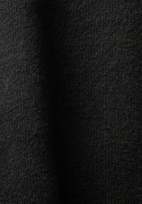 Tissu noir à surface texturée, présentant un tissage fin et doux avec de subtiles variations de teinte. Idéal pour les vêtements et accessoires.