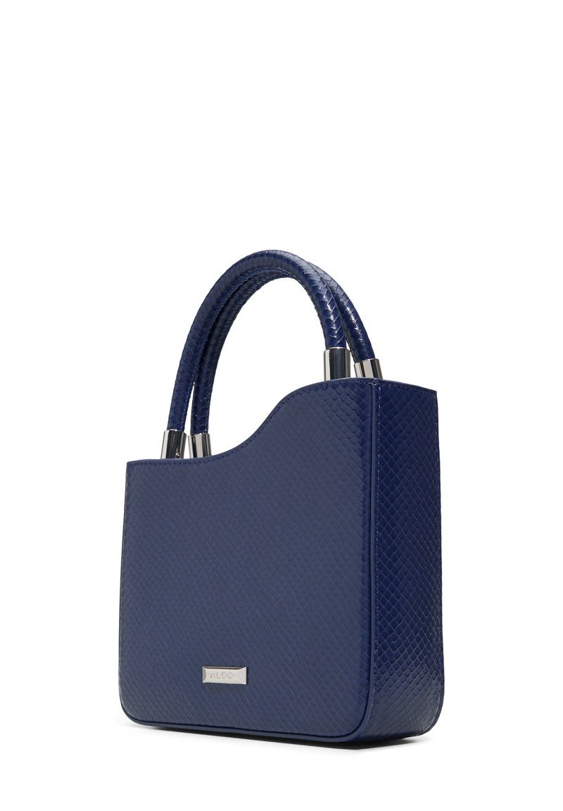 Sac à main bleu marine en matériau texturé avec deux poignées rondes, des accents métalliques et une plaque logo discrète à l'avant.