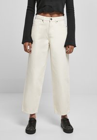 Breda ben, off-white jeans i kraftig bomull med hög midja och femfickdesign, med knappstängning och råa kanter.