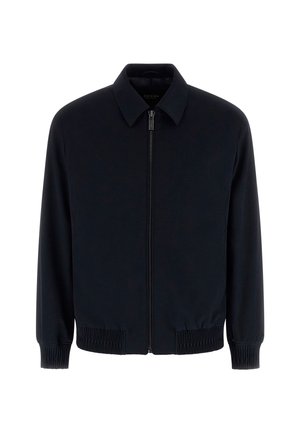 Marineblauw vest met rits, gemaakt van gladde stof. Heeft een kraag, elastische boorden en een comfortabele pasvorm met geribde zoom.