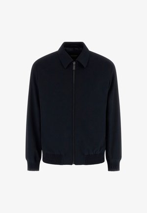 Marineblauw vest met rits, gemaakt van gladde stof. Heeft een kraag, elastische boorden en een comfortabele pasvorm met geribde zoom.