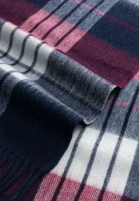 Wool scarf featuring a plaid pattern with dark blue, white, and burgundy colors, soft texture, and fringed edges for added detail.