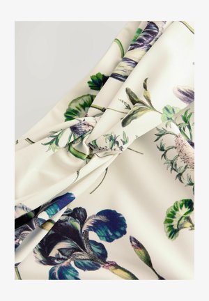 Tessuto stampato floreale in crema, con design botanici verdi e viola. Texture morbida con un dettaglio annodato al centro.