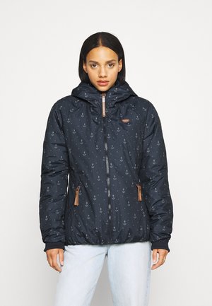 Navy puffer jacket with anchor print, zip closure, and hood; features faux leather accents and side pockets. Soft, textured material.