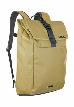 Brown textured backpack with a fold-over flap, black hardware, adjustable straps, and a logo positioned on the top front.