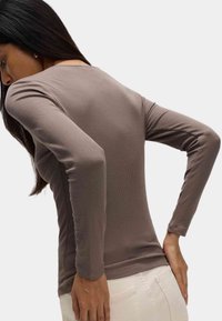 Lange mouwen geribbelde top in taupe, met een aansluitend ontwerp en ronde halslijn, van textuurstof met naadloze zijaccenten.