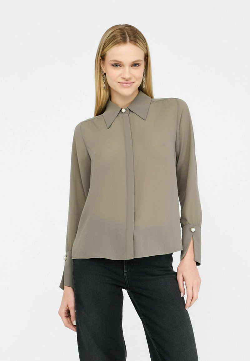 Gray, sheer button-up shirt with a pointed collar, long sleeves, and pearl accents at the cuffs. Soft, lightweight fabric with a loose fit.