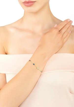 Gold-tone bracelet with multicolored floral accents in purple, blue, and white, featuring a delicate chain design.