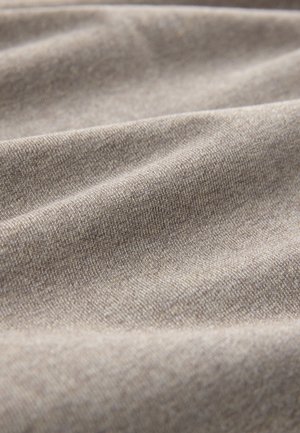 Tessuto marrone chiaro, strutturato con elasticità visibile; motivo sfumato sottilmente che aggiunge profondità; onde delicate che creano un aspetto morbido e drappeggiato.