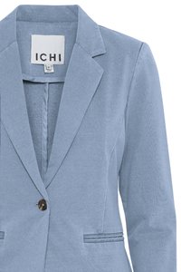Blazer albastru deschis pentru femei, cu revere tăiate, un singur nasture maro și două buzunare frontale orizontale. Eticheta indică "ICHI", mărimea mică.