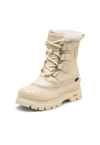 Botte imperméable couleur crème avec doublure en fausse fourrure, fermetures à lacets, partie inférieure en caoutchouc et semelle épaisse antidérapante. Présente des accents métalliques.