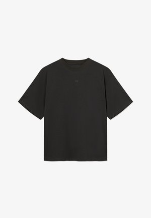 T-shirt noir oversized à manches courtes avec un col rond et un logo "WW" discret centré sous le col.
