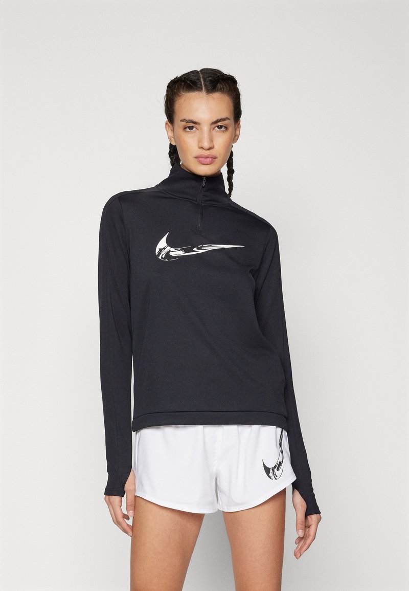 Black long-sleeve athletic shirt with a quarter zip and white Nike swoosh logo, paired with white athletic shorts featuring a small logo.