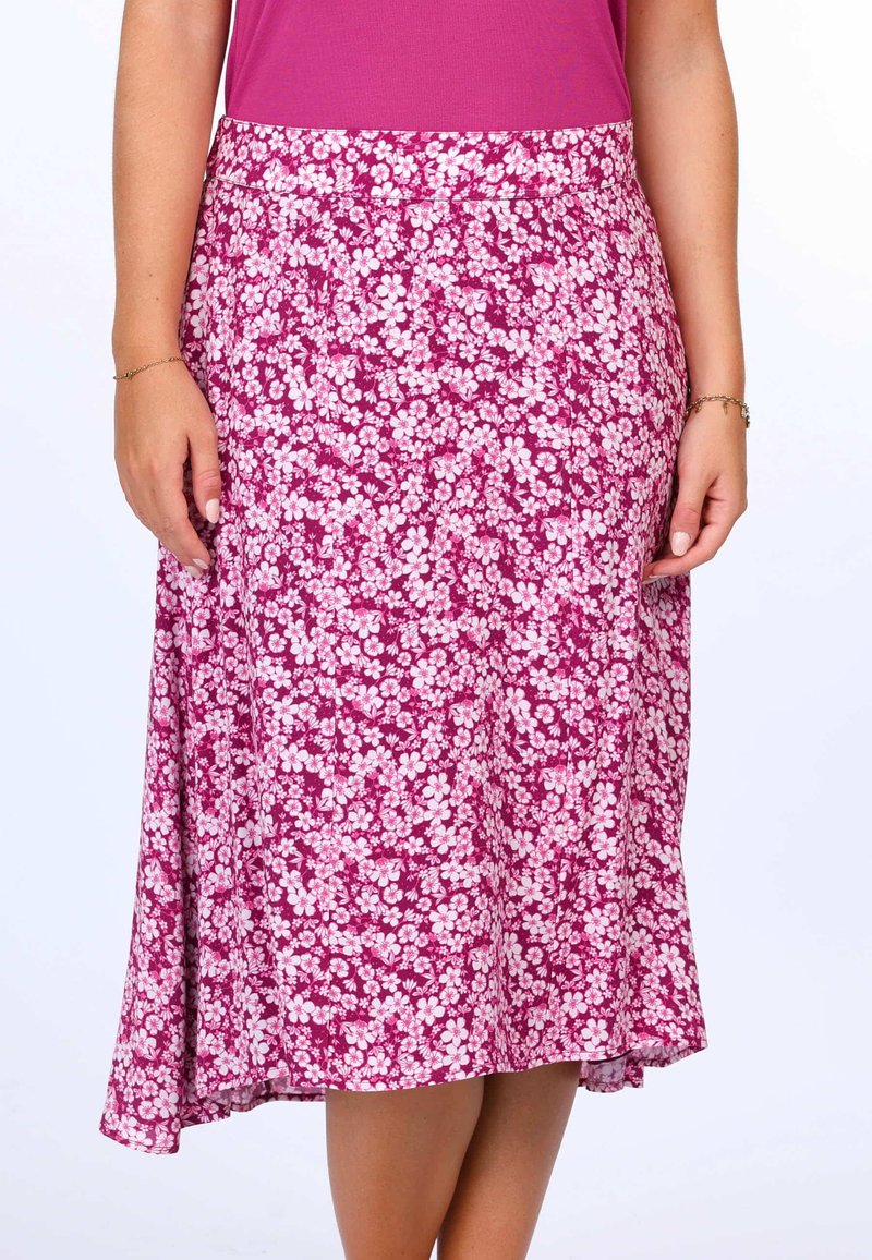 Blumiger Midirock mit einem lebhaften pinken Hintergrund und weißen Blumen, aus leichtem Stoff, mit einem ausgestellten Saum und einem elastischen Bund.