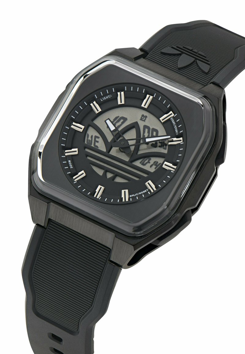 Black digital-analog wristwatch with rubber strap, square case, and Adidas logo integrated into the dial display and strap.