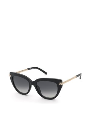 Lunettes de soleil œil de chat noires avec verres dégradés foncés et branches tressées dorées sur fond blanc.