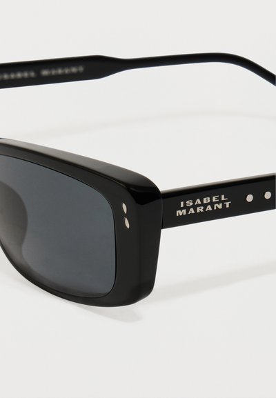 Zwarte zonnebril met een dikke, vierkante montuur en donkere glazen. Voorzien van gouden hardware accenten en gegraveerde merknaam op de poot.