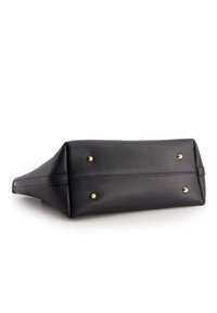 Black leather handbag with a structured shape, textured surface, and gold-tone hardware details. Features protective metal feet on the bottom.