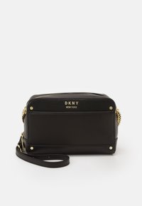 Borsa crossbody nera in pelle con hardware dorato e logo, dotata di chiusura a zip, accentuazione a catena e piccoli chiodini decorativi sulla parte inferiore.