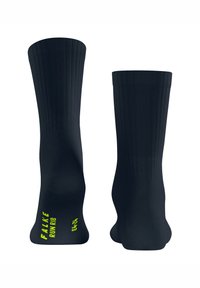 Czarne skarpetki z prążkowanej tkaniny o gładkiej fakturze, z logo w jaskrawym żółtym kolorze na spodzie. Zaprojektowane z myślą o komforcie i wydajności.