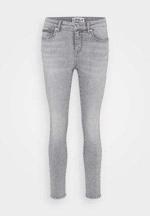 Graue Skinny Jeans aus Denim mit einem Fünf-Taschen-Design, Knopfverschluss und Gürtelschlaufen. Der Stoff hat eine glatte Textur und leichte Ausbleichungen.