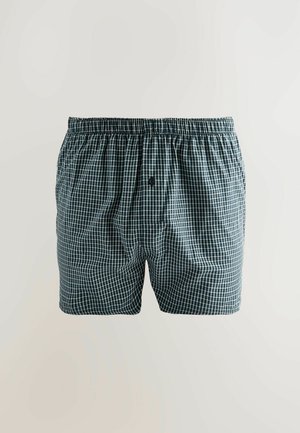 Boxershorts in donkergroen met een wit geruit patroon, gemaakt van geweven stof. Voorzien van een elastische tailleband en een knoopsluiting aan de voorkant.