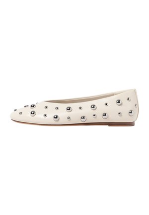 Cream leather ballet flats featuring a rounded toe, adorned with metallic silver studs in varying sizes on the upper. Flat sole design.
