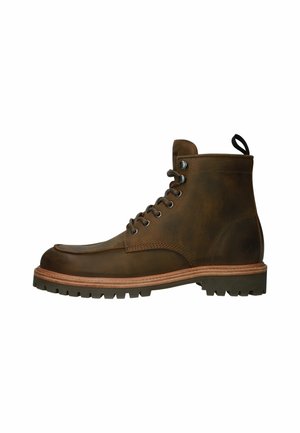 Brown leather ankle boot with a rounded toe, round laces, rubber sole, and contrasting tan midsole. Features a loop at the heel for easy wear.