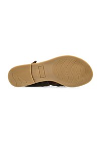 Zapato mocasín de ante marrón con suela de goma texturizada en tono marrón claro, que presenta un patrón ondulado y el logotipo de la marca grabado en la parte inferior.