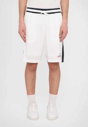 White mesh athletic shorts with a drawstring waist, side navy accents, and red text detail, featuring side pockets and a relaxed fit.