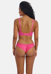 Rosa Bikini-Set mit einem strukturierten Bralette mit verstellbaren Trägern und einem Verschluss auf der Rückseite, kombiniert mit einem passenden niedrig geschnittenen Unterteil. Glatte Textur.