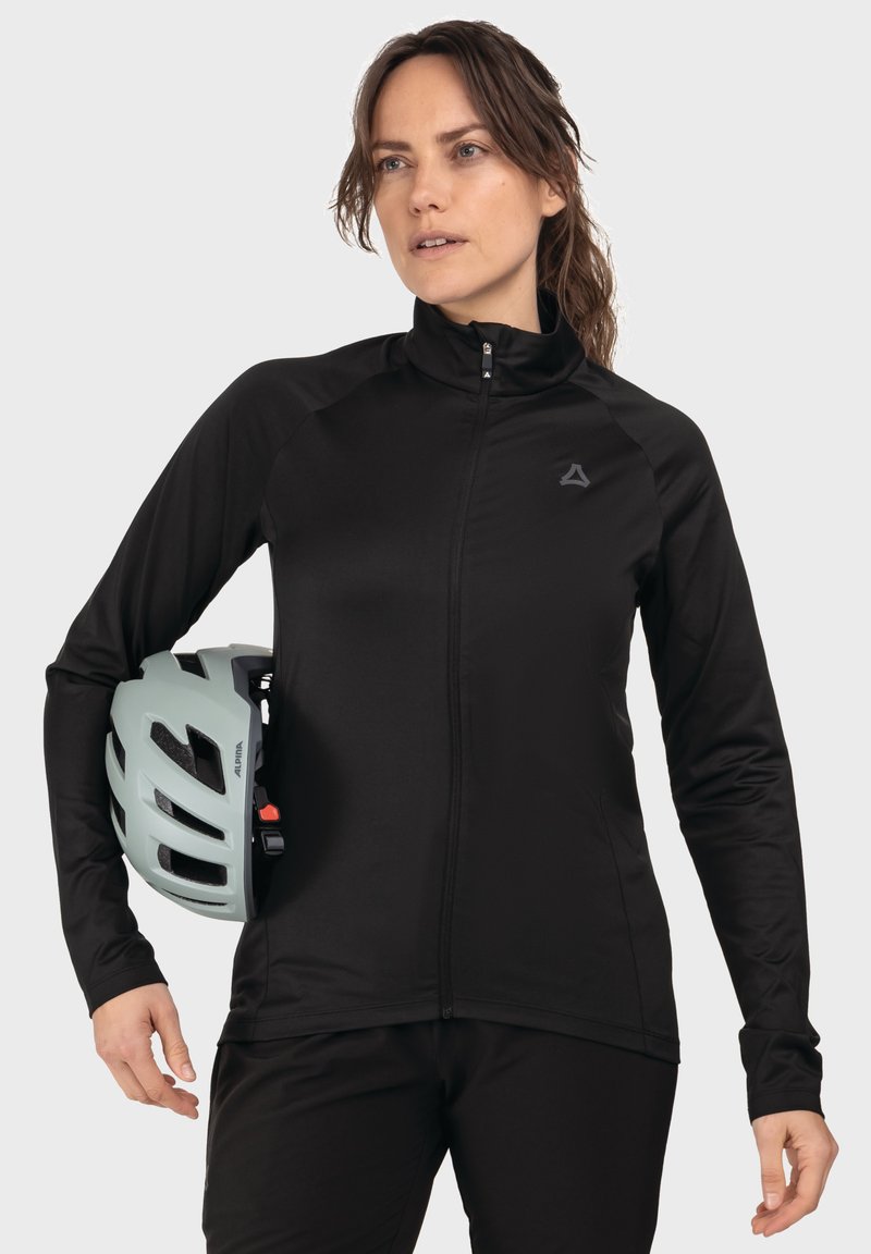 Schwarze Zip-Jacke aus weichem, atmungsaktivem Material mit langen Ärmeln. Kombiniert mit einem hellgrünen Fahrradhelm, der ein schlankes Design aufweist.