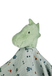 Green plush dragon head with soft texture and pointy ears atop a light blue blanket featuring scattered dinosaur patterns in various colors.