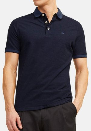 Marine polo shirt van katoen met een kraag en knoopsluiting met drie knopen; heeft een contrasterende kraag en mouwafwerking; getailleerd ontwerp.