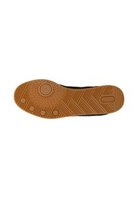 Semelle de chaussure avec semelle en caoutchouc marron présentant des motifs circulaires et des lignes rainurées, conçue pour l’adhérence et la durabilité.