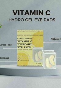 Poduszki żelowe pod oczy z witaminą C w żółtym opakowaniu z grafiką cytryny, zawierające trzy przezroczyste opakowania z poduszkami żelowymi w kształcie półksiężyca.