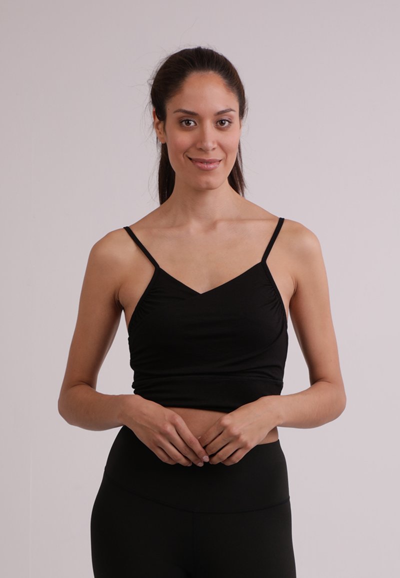 Czarny crop top na cienkich ramiączkach z dekoltem w kształcie litery V, o marszczonej teksturze i dopasowanej sylwetce, wykonany z miękkiego, elastycznego materiału.