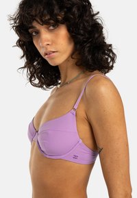Top bikini viola con ferretto, dotato di sottili spalline regolabili, design senza cuciture e un sottile accento con logo, realizzato in tessuto liscio e elastico.