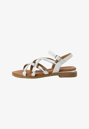 White strappy sandals featuring metallic accents, a brown footbed, and a buckle closure on the ankle strap. Flat sole design.