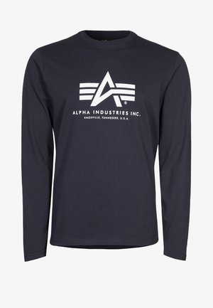 Chemise à manches longues bleu marine avec logo blanc Alpha Industries Inc. et texte "Knoxville, Tennessee, U.S.A." centré sur le devant.