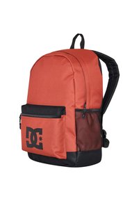 Red backpack with a rounded shape, made of durable fabric, featuring a black mesh pocket, zipper closures, and a large logo on the front.